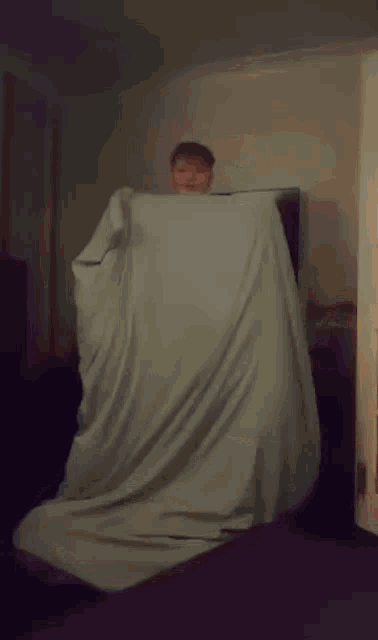 a person laying on a couch in front of a television