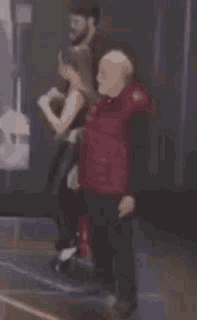 a blurry picture of a man and a woman dancing in a club .