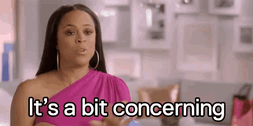 a woman in a pink dress is standing in a room and says `` it 's a bit concerning '' .