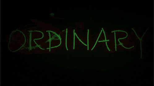 the word ordinary is glowing green in the dark