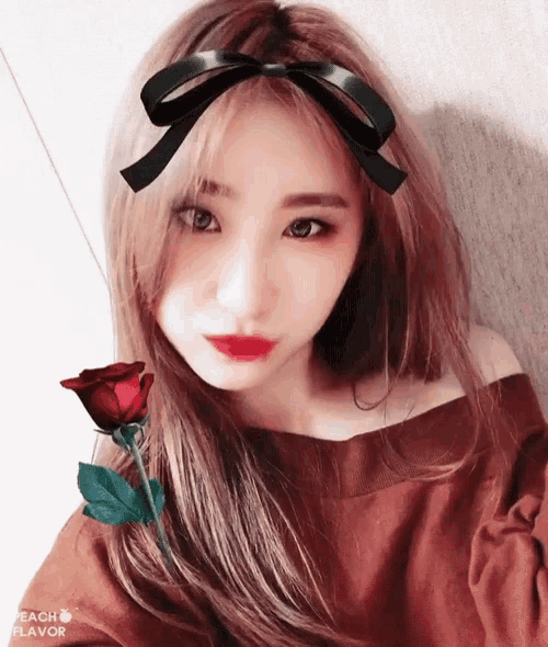 a woman with a black bow on her head holds a rose in her hand