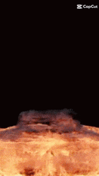 a large piece of meat is flying through the air in a fire explosion .
