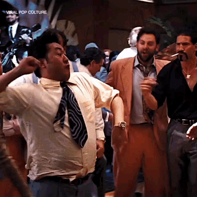 a group of men are dancing in a room with the words viral pop culture on the bottom right
