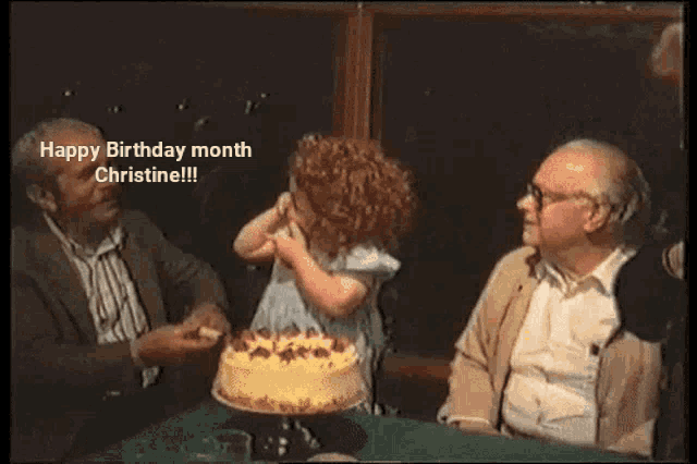 a man is blowing out candles on a birthday cake while a group of people celebrate .