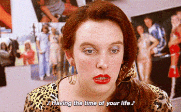 a woman says having the time of your life in front of pictures
