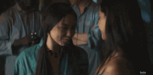 a blurred image of a group of people dancing with the hulu logo in the corner