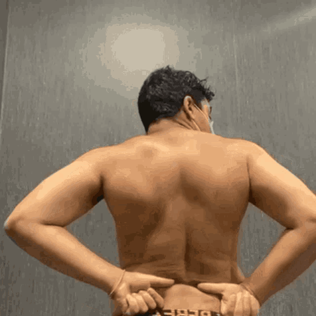 a shirtless man has a tattoo on his back that says ' ep '