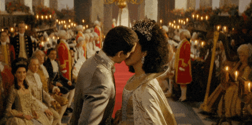 a man and woman kissing in front of a crowd