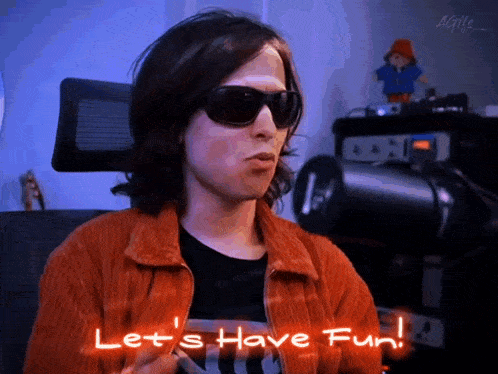 a person wearing sunglasses and an orange jacket says let 's have fun