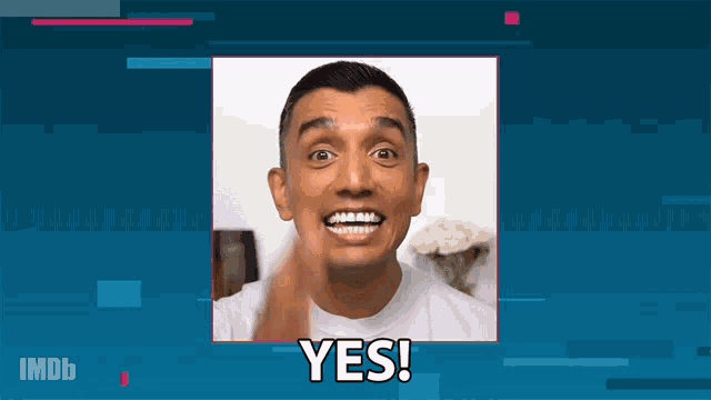a man in a white shirt is making a face and says yes