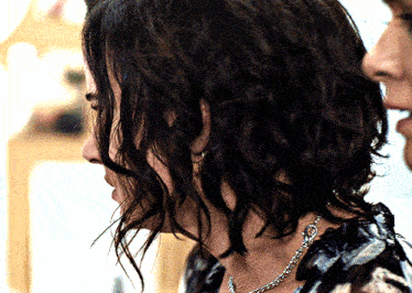 a close up of a woman 's neck and hair