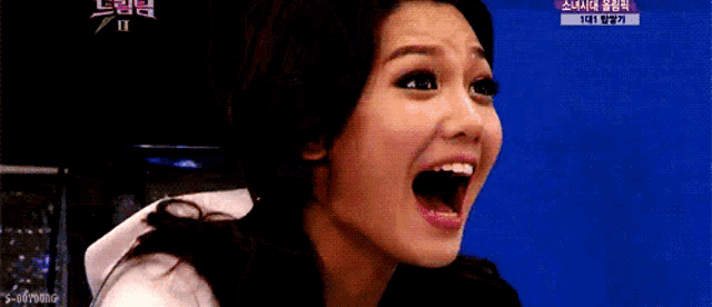 a woman is making a funny face with her mouth open