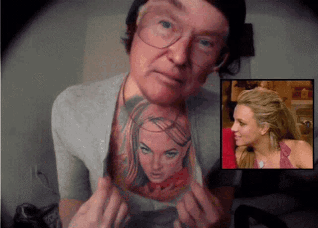 a man has a tattoo of a woman on his chest and a picture of a woman behind him