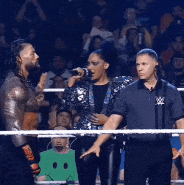 a man and a woman are in a wrestling ring with a referee and a smiley face in the background