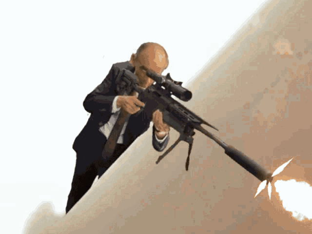 a man in a suit and tie is pointing a sniper rifle at something