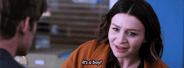 a woman is talking to a man and saying it 's a boy .