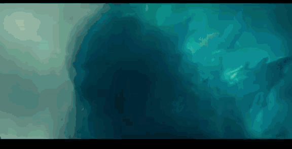 a close up of a person swimming in the water in a movie .