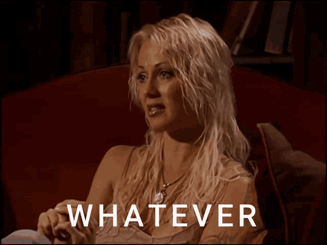 a woman is sitting in a chair with the word whatever written on the screen