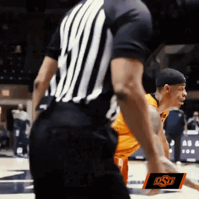 a basketball game is being played with an osu logo on the bottom