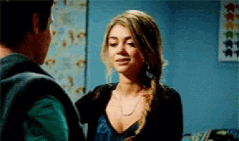 a man and a woman are standing next to each other in a room .