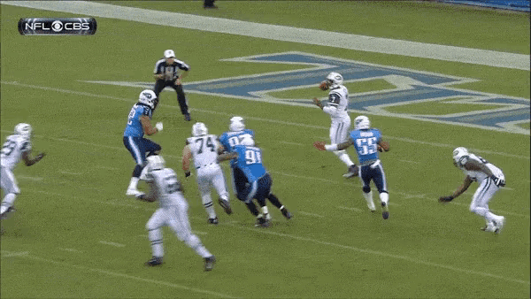 a football player with the number 92 on his jersey is being tackled by another player