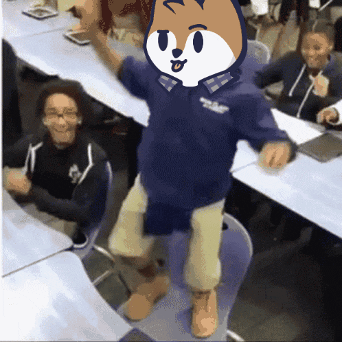 a person wearing a blue shirt with a fox on it is dancing in a classroom