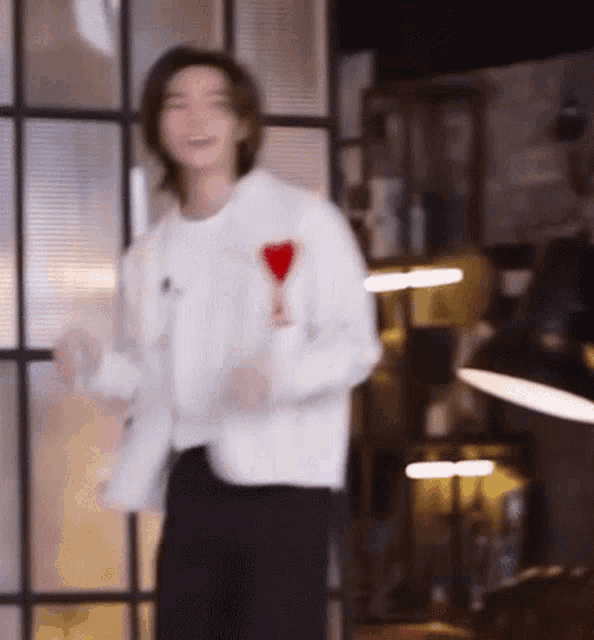 a man in a white jacket is holding a glass of wine