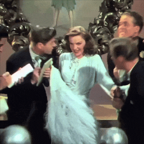 a woman in a white dress is being held by a man in a tuxedo