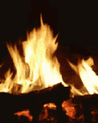 a close up of a fire burning in a fireplace at night