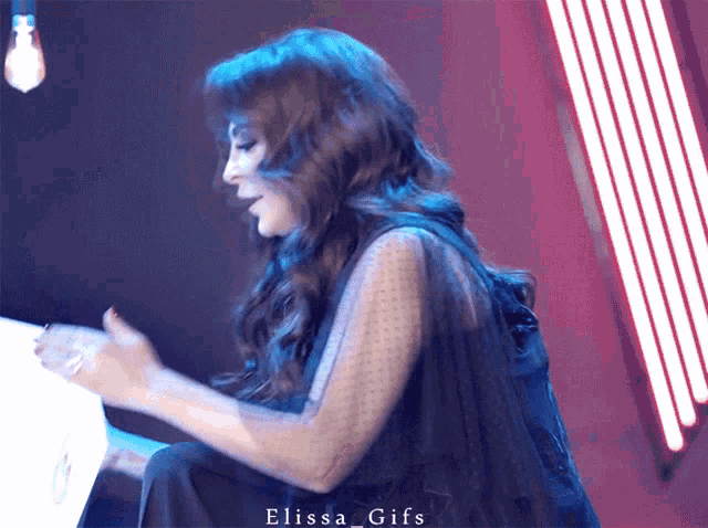 a gif of a woman with the name elissa gifs on the bottom