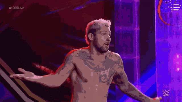 a man without a shirt is standing in front of a sign that says 205 live