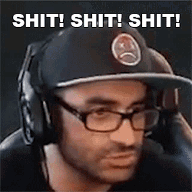 a man wearing glasses , headphones and a hat with the words shit ! shit ! shit !