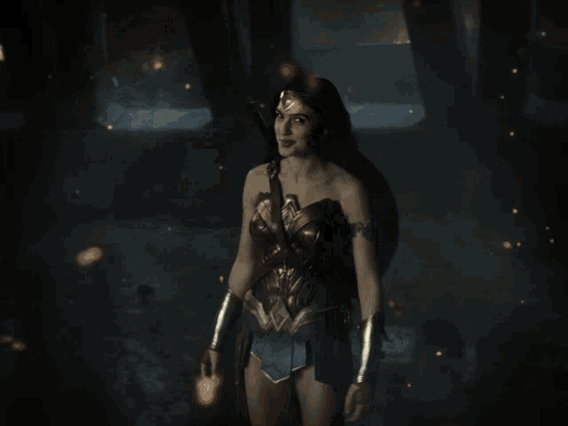 a woman in a costume is holding a light beam in her hand