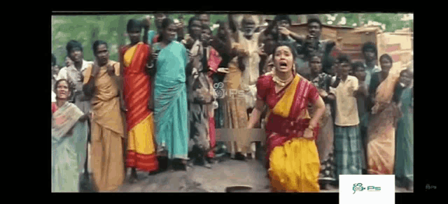 a woman in a yellow saree is screaming in front of a crowd