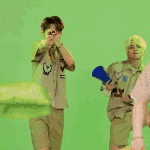 a man is holding a megaphone while another man holds a camera .