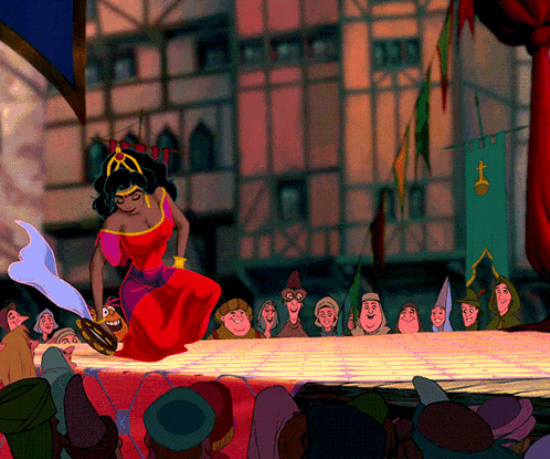 a woman in a red dress is dancing in front of a crowd of people