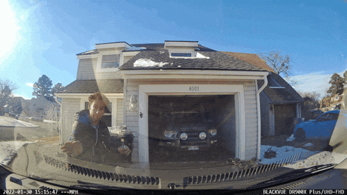 a car is parked in front of a house that has the number 4001 on it