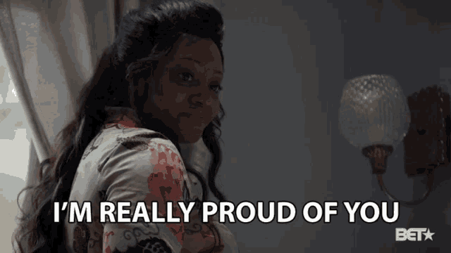 a woman says " i 'm really proud of you " in front of a light