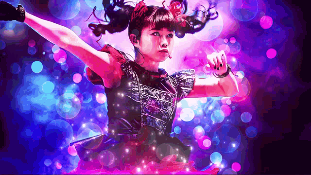 a girl with pigtails is dancing in front of a purple background