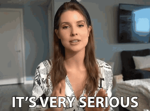 a woman says it 's very serious while wearing a newspaper print shirt