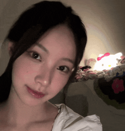 a girl taking a selfie in front of a hello kitty