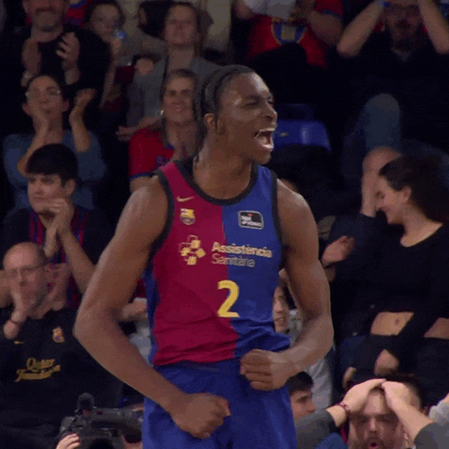 a basketball player wearing a number 2 jersey stands in front of a crowd