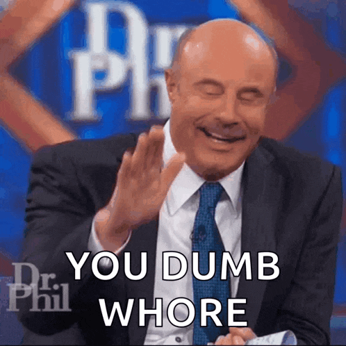 a bald man in a suit and tie is laughing and saying you dumb whore