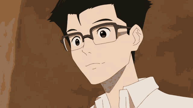 a man with glasses and a white shirt is smiling