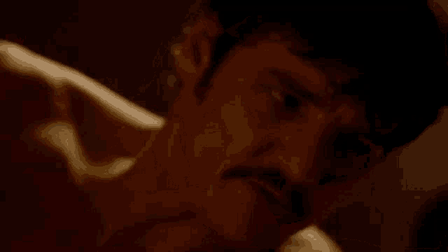 a close up of a man 's face with a mustache .