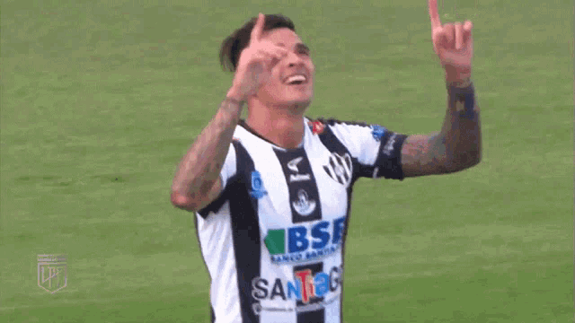 a soccer player wearing a black and white jersey that says bse and santiago