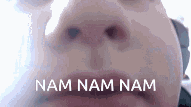 a close up of a person 's face with the words nam nam nam written above it