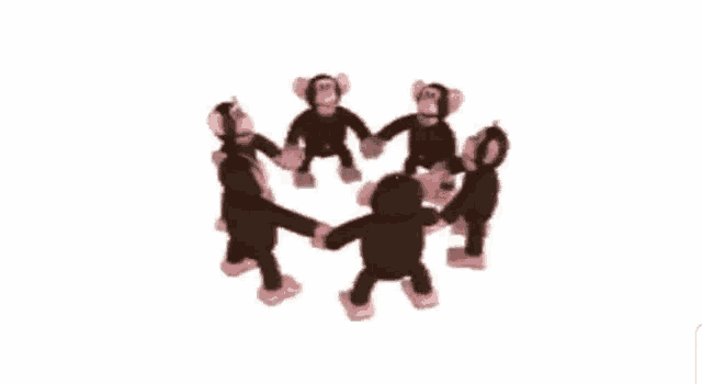 a group of stuffed monkeys are standing in a circle holding hands .