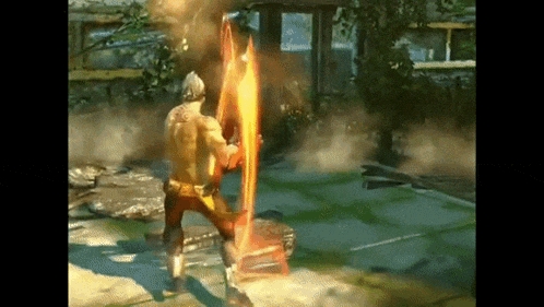 a man in a video game is holding a sword with flames coming out of it