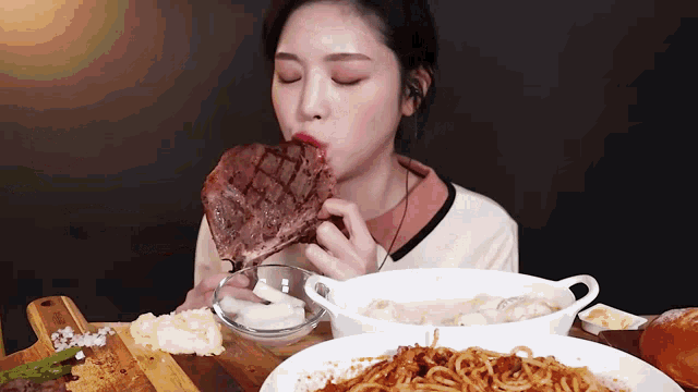 a woman is eating a large piece of meat from a bowl .